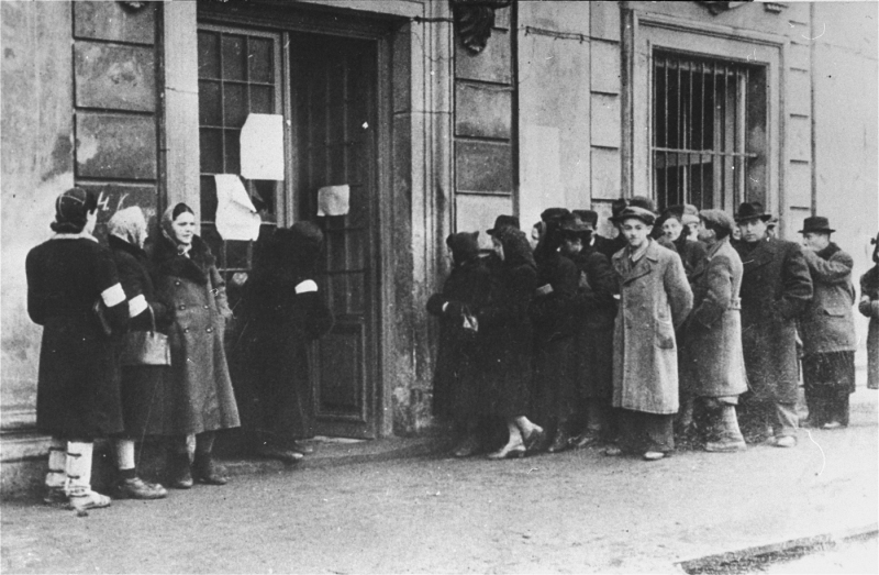 Jews waiting in line outside the Judenrat in Krakow to register for apartments in the ghetto. c. 1940 [United States Holocaust Memorial Museum]